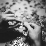 grayscale photo of person holding flower